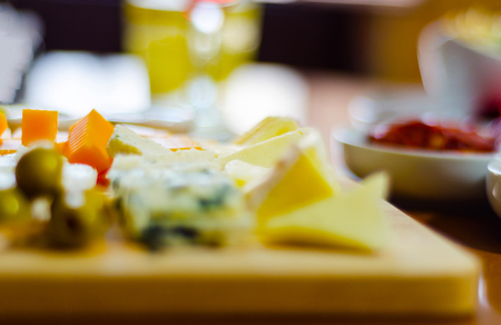 set of different cheeses on a wooden board, cheese board, delicious snack, healthy and exclusive food, cheese setの写真素材