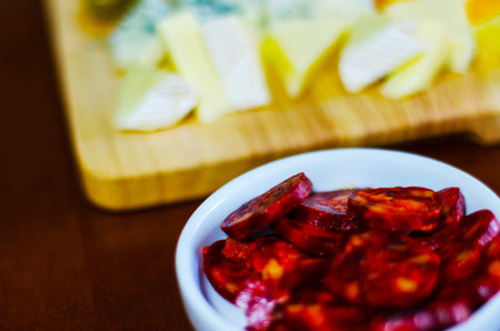 set of traditional Spanish sausages, side dishes of thinly sliced different chorizo, sets of meats,...