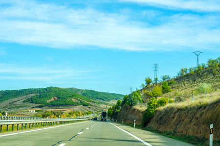 Fast road in the mountains in Spain, beautiful landscape of mountains, dry earth and rock from the sun, transportationの写真素材