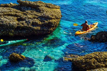 Senior kayaker on a kayak by the sea, active water sport and leisure, kayakingの写真素材