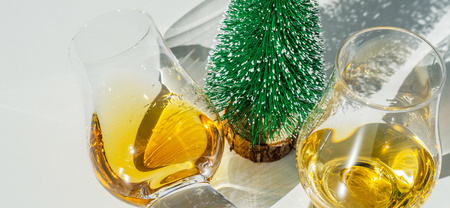 single malt whisky  in the glass with decorative Christmas tree, luxurious tasting glass, tasty setの写真素材