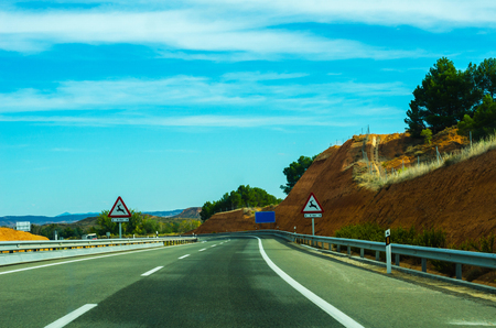 Fast road in the mountains in Spain, beautiful landscape of mountains, dry earth and rock from the sun, transportationの写真素材