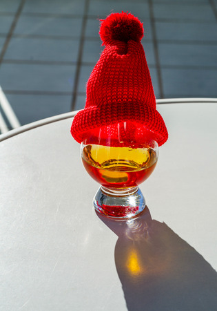 Single Malt Whiskey in a glass with a red cap, luxury tasting glass, tasty setの写真素材