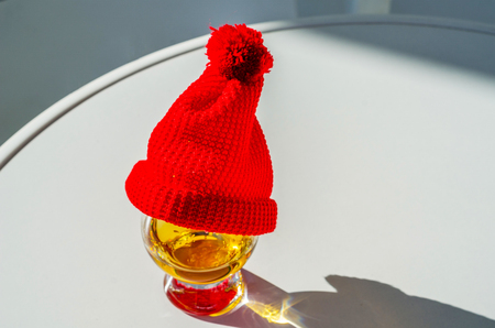 Single Malt Whiskey in a glass with a red cap, luxury tasting glass, tasty setの写真素材