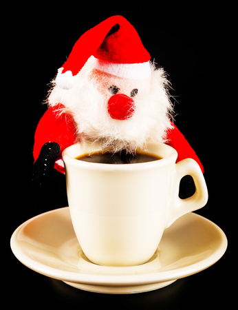 black coffee in a white cup and plush Santa Claus, drink set, tasty drinkの写真素材