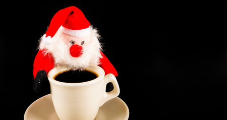 black coffee in a white cup and plush Santa Claus, drink set, tasty drinkの写真素材