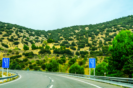 Fast road in the mountains in Spain, beautiful landscape of mountains, dry earth and rock from the sun, transportationの写真素材