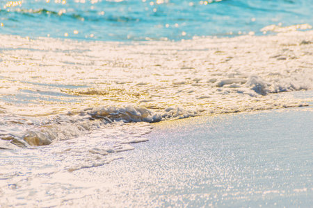close up of the sea water affecting the sand on the beach, sea waves calmly flowing sand, relaxing...