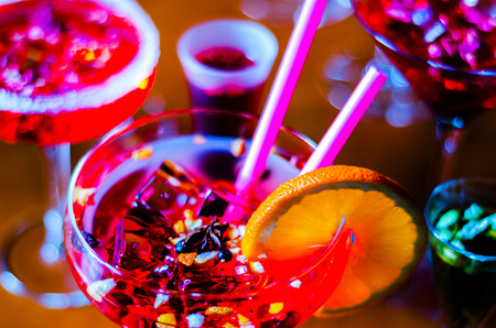 Tasty and colorful drinks based on various alcohols, syrups and liqueurs, unique effect of the bartender's work, party nightの写真素材