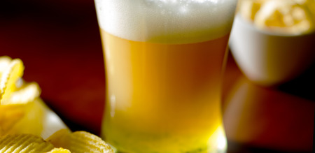 pint of lager beer in a glass, set of various snacks, a standard set of drinking and eating in a pub, beer and snacksの写真素材