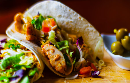 Tasty fresh wrap sandwich with meat, vegetables and cheese, delicious snack, healthy foodの写真素材