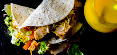 Tasty fresh wrap sandwich with meat, vegetables and cheese, delicious snack, healthy foodの写真素材