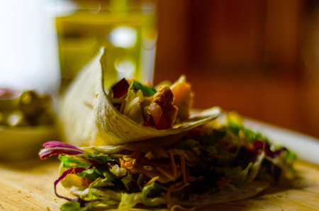 Tasty fresh wrap sandwich with meat, vegetables and cheese, delicious snack, healthy foodの写真素材