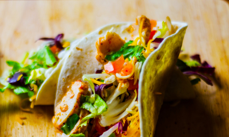 Tasty fresh wrap sandwich with meat, vegetables and cheese, delicious snack, healthy foodの写真素材