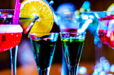Tasty and colorful drinks based on various alcohols, syrups and liqueurs, unique effect of the bartender's work, party nightの写真素材