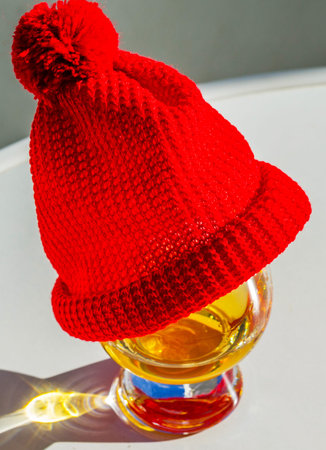 Single Malt Whiskey in a glass with a red cap, luxury tasting glass, tasty set