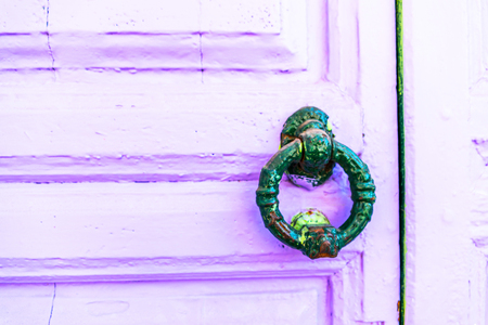 Door with brass knocker in the shape of a decor,  beautiful entrance to the house, vintage decorationの写真素材