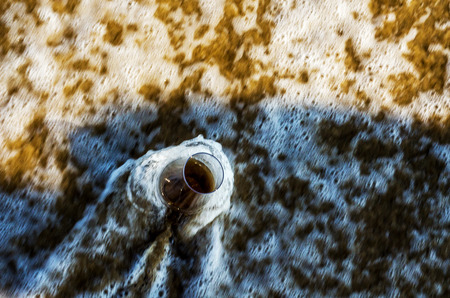 A glass of whiskey single malt on the sand washed by the waves, a glass of tasting, relax on the beach, vacationの写真素材