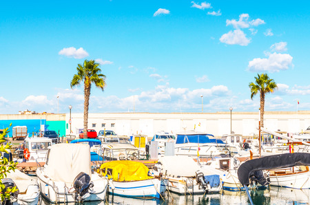 Beautiful luxury yachts and motor boats anchored in the harbor, hot summer day and blue water in the marina, blue sky, vacationの写真素材