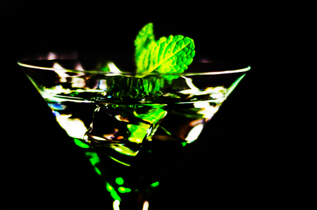 Green mint liqueur, refreshing drink with fresh mint, energizing cocktail, party nightの写真素材