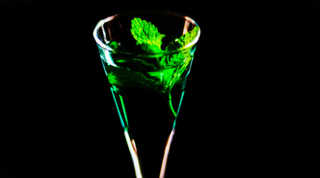 Green mint liqueur, refreshing drink with fresh mint, energizing cocktail, party nightの写真素材