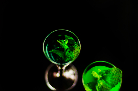 Green mint liqueur, refreshing drink with fresh mint, energizing cocktail, party nightの写真素材