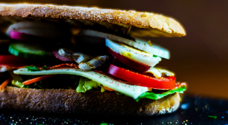 Grilled sandwich with various cold meats, cheese, mushrooms, tomato and egg, tasty and healthy snack, hot foodの写真素材