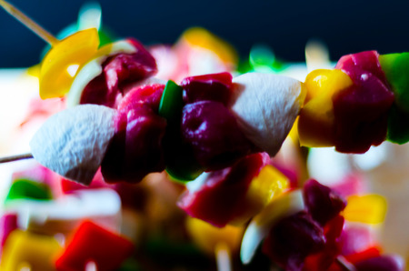 Skewers with meat and vegetables prepared for grilling on a wooden board, colorful and tasty dishの写真素材