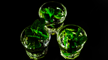Green mint liqueur, refreshing drink with fresh mint, energizing cocktail, party nightの写真素材