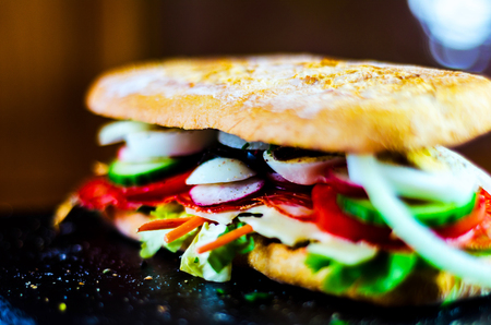 Grilled sandwich with various cold meats, cheese, mushrooms, tomato and egg, tasty and healthy snack, hot foodの写真素材