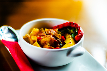 Traditional Hungarian goulash with beef, potatoes, tomatoes and peppers, a tasty dish in a white bowl, nutritious dishの写真素材
