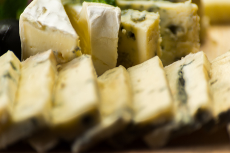 Set of different cheeses on a wooden board, cheese board, delicious snack, healthy and exclusive food, cheese setの写真素材