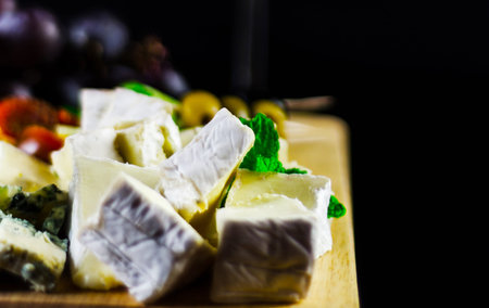 set of different cheeses on a wooden board, cheese board, delicious snack, healthy and exclusive...