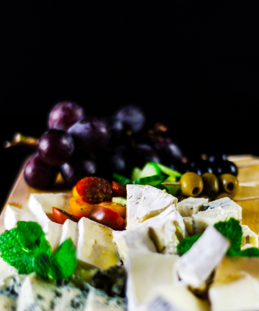 set of different cheeses on a wooden board, cheese board, delicious snack, healthy and exclusive food, cheese setの写真素材