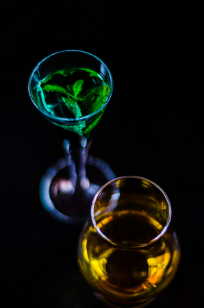 single malt whiskey in a glass and green mint liqueur, refreshing set of drinks, taste sensationsの写真素材