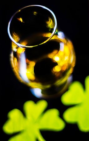 Single malt whisky in a glass of tasting with decoration for St. Patrick's day, green clover symbol for Irish holiday, festiveの写真素材