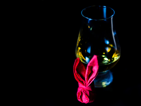 Single malt whiskey in a glass of tasting with napkin bunny, festive Easter decoration, holidayの写真素材