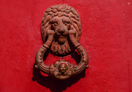 Door with brass knocker in the shape of a decor,  beautiful entrance to the house, vintage decorationの写真素材