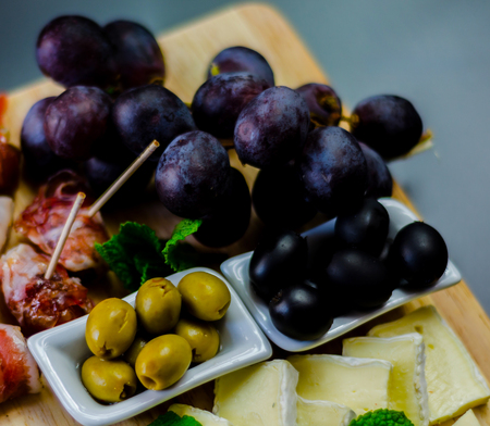 set of different cheeses on a wooden board, cheese board, delicious snack, healthy and exclusive food, cheese setの写真素材