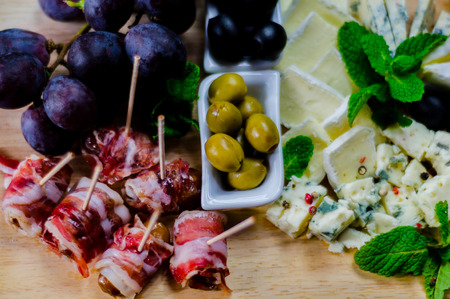 set of different cheeses on a wooden board, cheese board, delicious snack, healthy and exclusive food, cheese setの写真素材