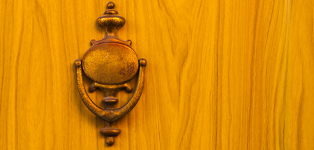 Door with brass knocker in the shape of a decor,  beautiful entrance to the house, vintage decorationの写真素材