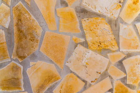 old stone placed in the wall, interesting and original background, solid wall
