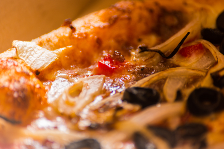 Close up on delicious pizza in cardboard, pizza delivered to your home in a special packaging, fast foodの写真素材
