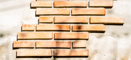 Old brick placed in the wall, interesting and original background, solid wall