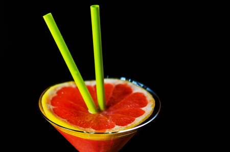 Healthy smoothie with ripe pomelo fruit in a glass, a drink decorated with a slice of pomelo, pink drinkの写真素材