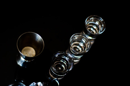 Traditional pure vodka in glasses on a black background, chilled drink, nightlifeの写真素材