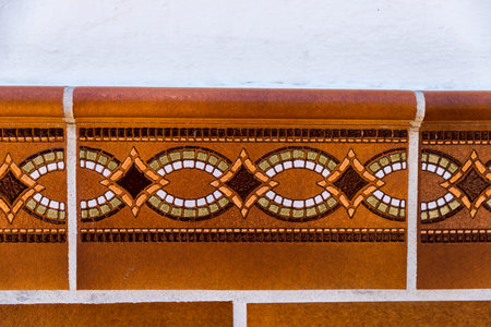 Traditional ornamental Spanish decorative tiles, original ceramic tiles on the walls of buildings,...