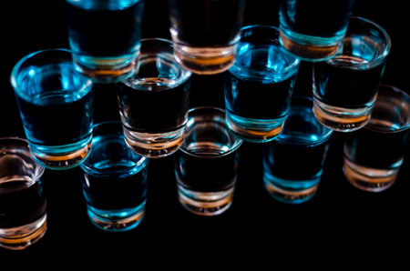 Popular drink shot kamikaze based on vodka, blue curacao and lemon juice, refreshing drink, party...