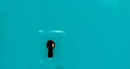 Keyhole in an old door with an interesting texture, a remnant of an old entrance security, vintage