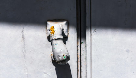 Door with brass knocker in the shape of a hand,  beautiful entrance to the house, vintage decorationの写真素材